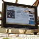 LCD enclosure mounted on the roof beams at a  train station