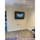 Autism TV protection cabinet mounted to the wall in a home setting
