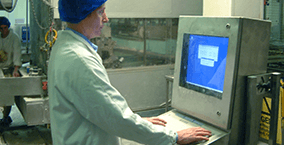 A food processing worker using a waterproof PC enclosure from Armagard