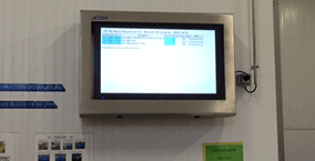 A wall-mounted production display for hygienic applications