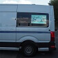 Digital display van 32" screen installed in the rear window of a work van