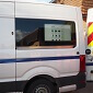 Van-side digital 32" screen mounted in the back of a work van