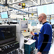 A factory worker using displays with industrial TV screen protection