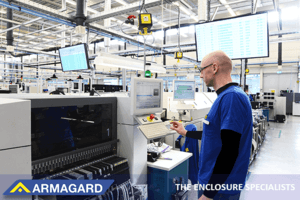 A factory worker using displays with industrial TV screen protection