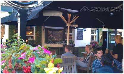 LCD enclosure installation - people sat in a beer garden watching tv housed in an armagard enclosure